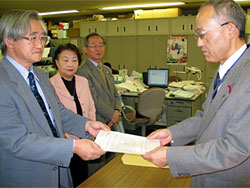 要請文を手渡す生協連・熊谷純一会長(左)